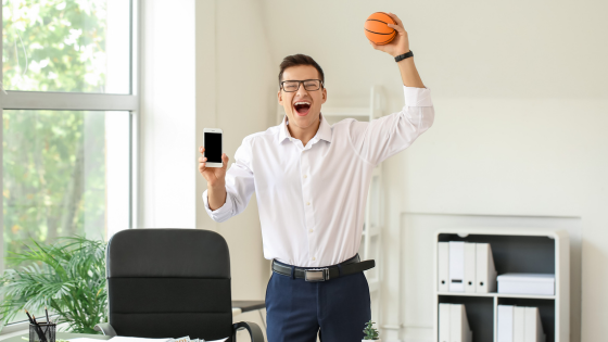 A sports betting fan cheering after winning in online betting